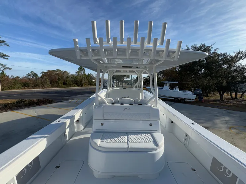 Slide: The Image of 2025 Yellowfin 39 Offshore boat with spacious deck and rod holders, parked outdoors. - 53