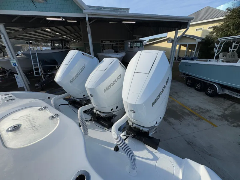 Slide: The Image of 2025 Yellowfin 39 Offshore boat with triple Mercury outboard engines in a marina. - 58