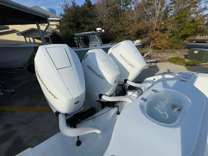 Slide: The Image of 2025 Yellowfin 39 Offshore boat with triple Mercury outboard engines, docked outdoors. - 59