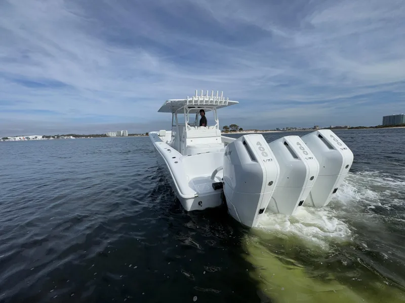 Slide: The Image of 2025 Yellowfin 39 Offshore boat cruising on open water with triple engines. - 6