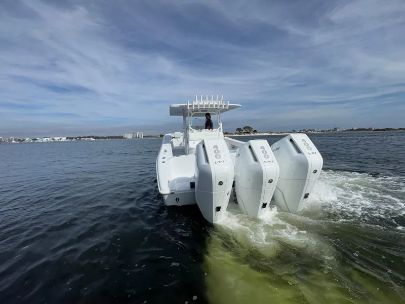 Slide: The Image of 2025 Yellowfin 39 Offshore boat with triple engines cruising on open water. - 7