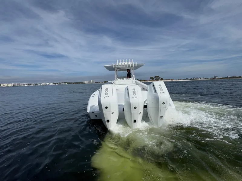 Slide: The Image of 2025 Yellowfin 39 Offshore boat with triple outboard engines cruising on open water. - 9