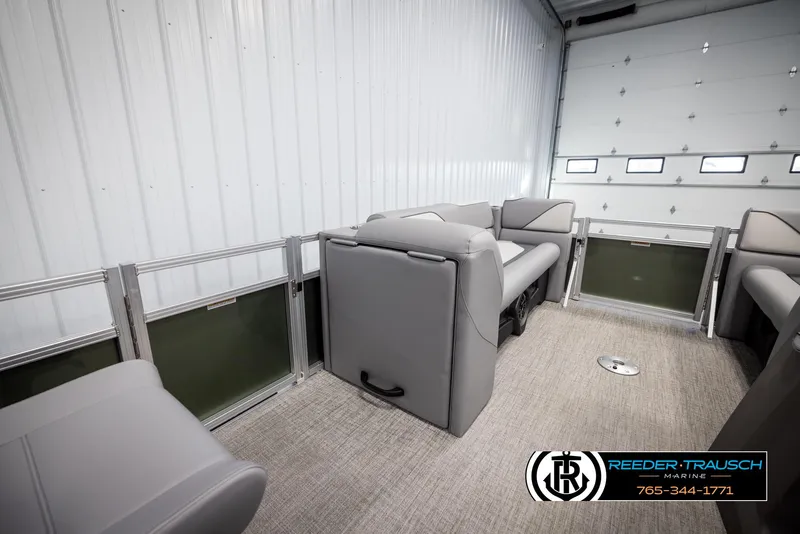 Slide: The Image of 2025 Avalon VEN QL boat interior with gray seating in a garage setting. - 21