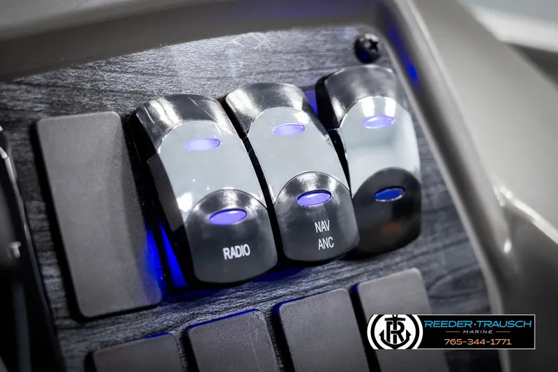 Slide: The Image of Switch panel of 2025 Avalon VEN QL boat with radio and navigation controls. - 32