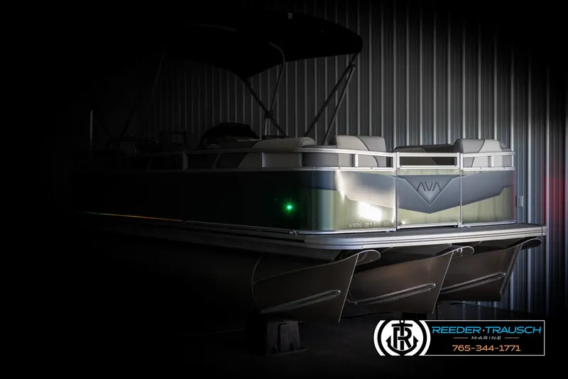 Slide: The Image of 2025 Avalon VEN QL boat in dimly lit storage, showcasing sleek design and modern features. - 4