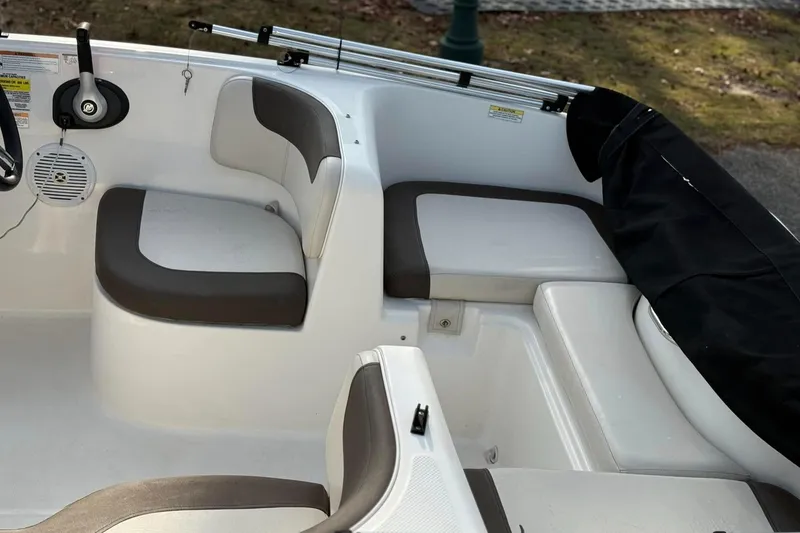 Slide: The Image of 2021 Bayliner Element 160EL boat interior with cushioned seating and steering wheel. - 3