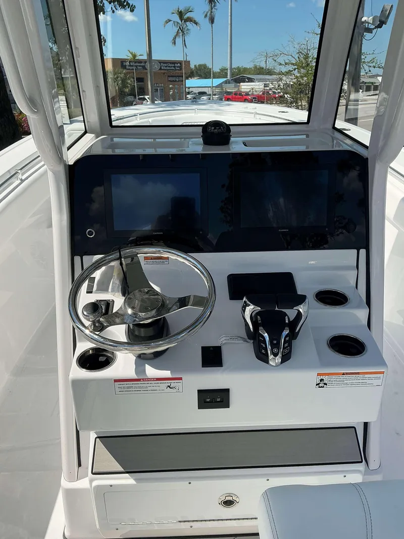 Slide: The Image of 2025 Sportsman 262 Open boat dashboard with steering wheel and control panel. - 10