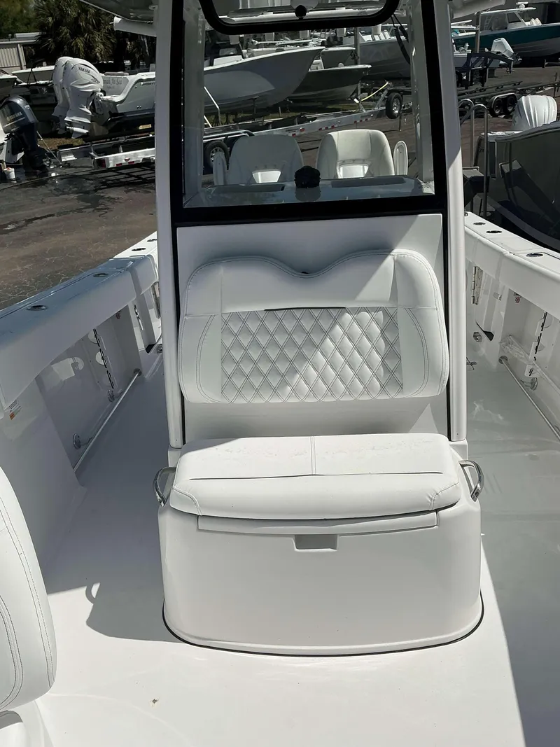 Slide: The Image of 2025 Sportsman 262 Open boat interior with white cushioned seating and console. - 11