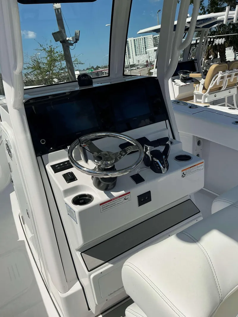 Slide: The Image of 2025 Sportsman 262 Open boat console with steering wheel and controls. - 13