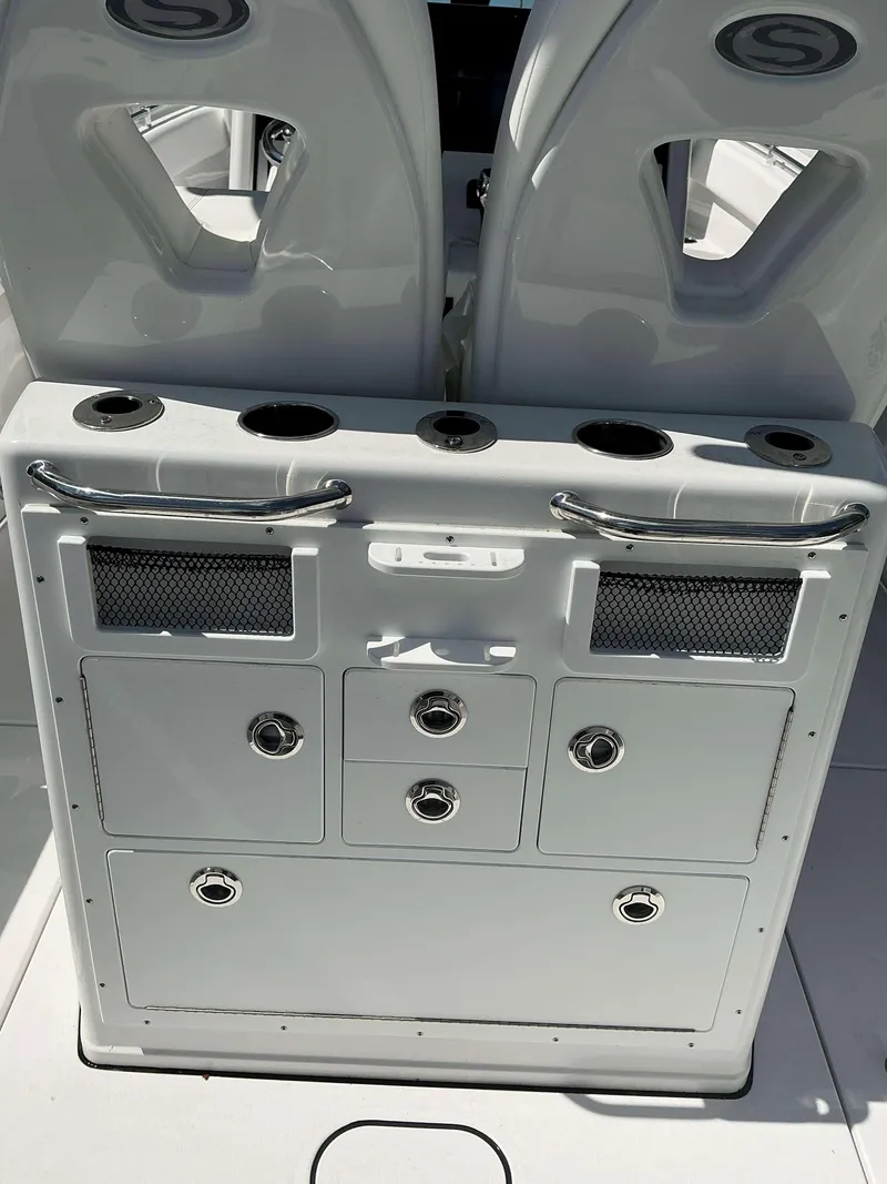 Slide: The Image of 2025 Sportsman 262 Open boat console with storage compartments and cup holders. - 15