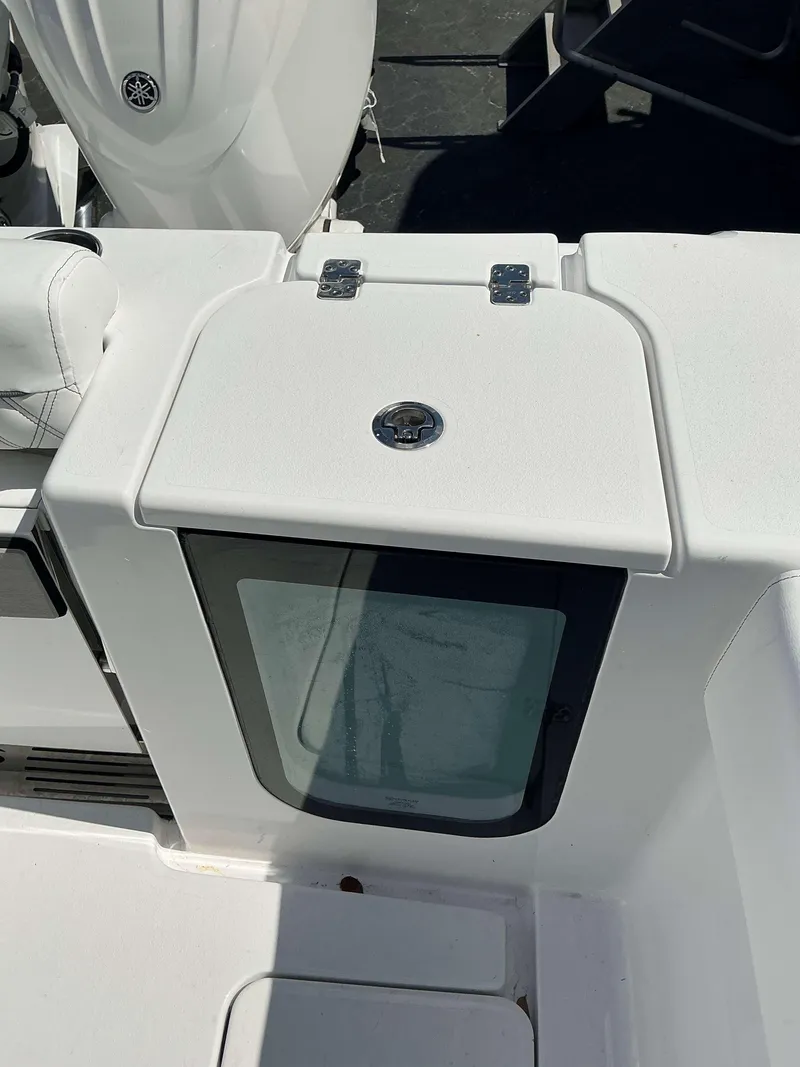 Slide: The Image of 2025 Sportsman 262 Open boat deck with storage compartment and seating. - 18