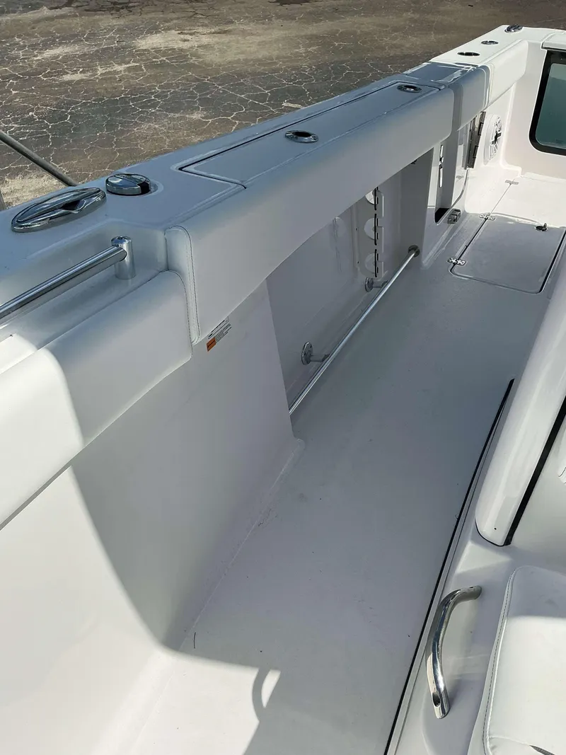 Slide: The Image of 2025 Sportsman 262 Open boat interior with sleek white design and stainless steel fittings. - 19