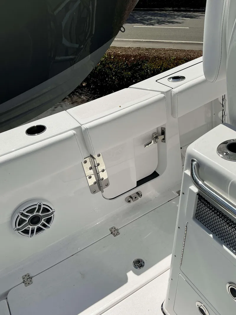 Slide: The Image of 2025 Sportsman 262 Open boat interior, featuring storage compartments and speaker. - 21