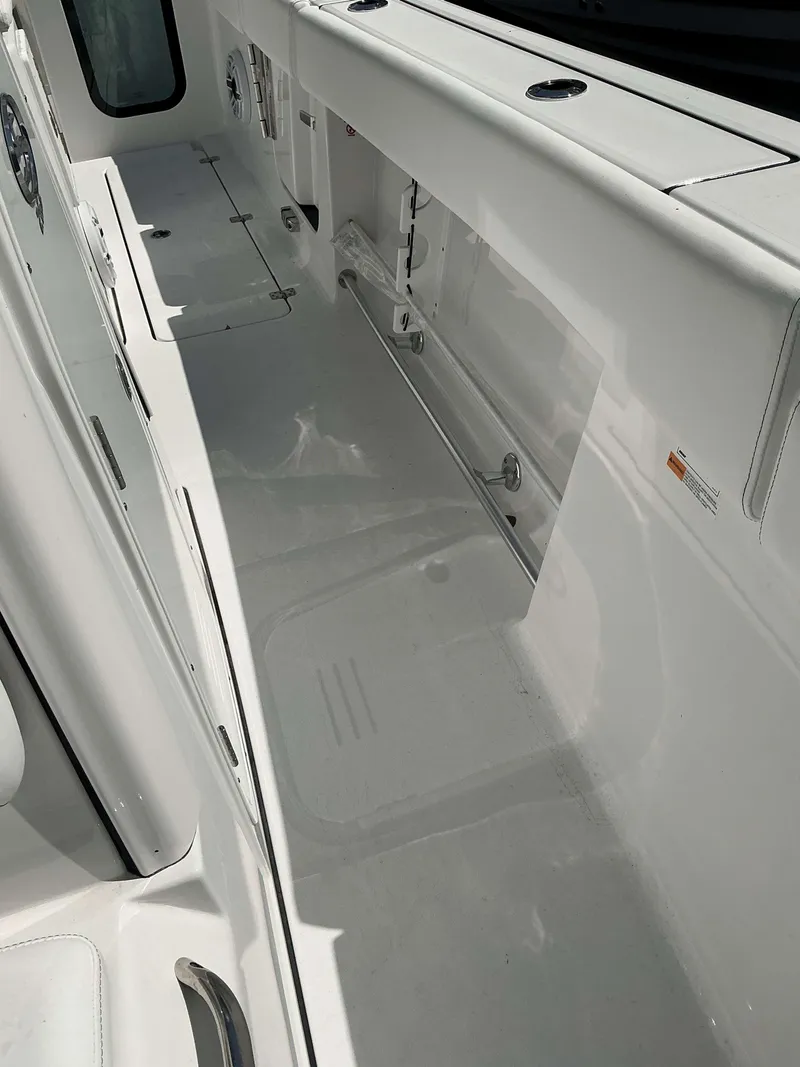 Slide: The Image of 2025 Sportsman 262 Open boat interior, featuring spacious white deck and storage compartments. - 23