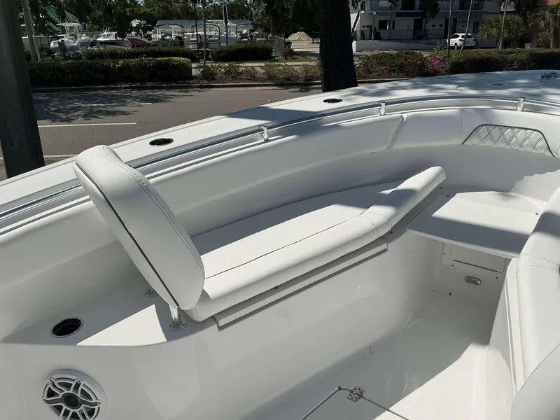 Slide: The Image of 2025 Sportsman 262 Open boat interior with white seating and speaker. - 5