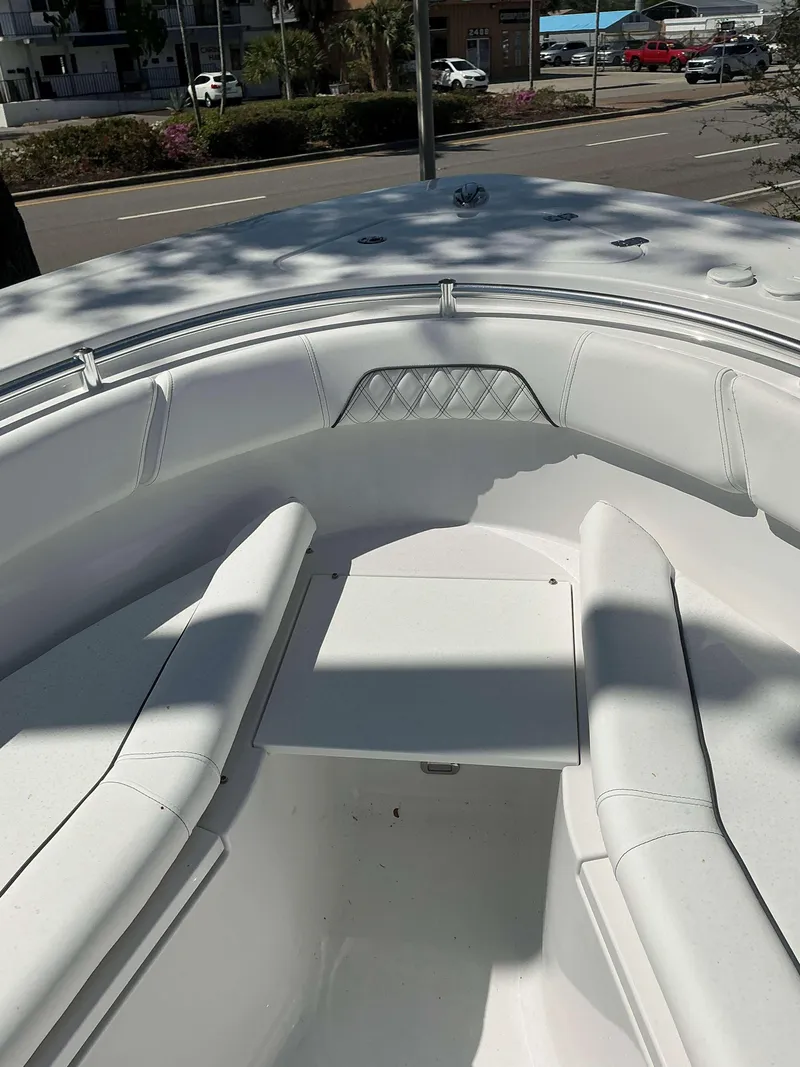 Slide: The Image of 2025 Sportsman 262 Open boat interior with white seating and storage compartment. - 7
