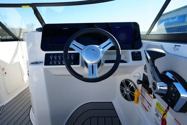 Slide: The Image of 2025 Sea Ray SDX 250 helm with modern steering wheel and controls. - 10