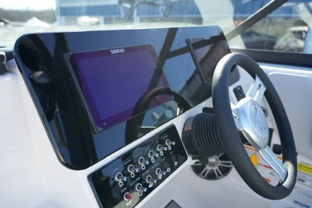 Slide: The Image of 2025 Sea Ray SDX 250 helm with modern controls and navigation display. - 11