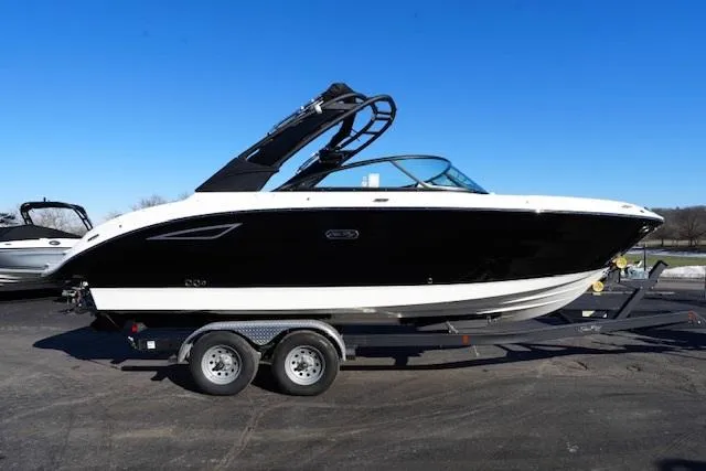 Slide: The Image of 2025 Sea Ray SDX 250 boat on trailer, black and white design, parked outdoors. - 4