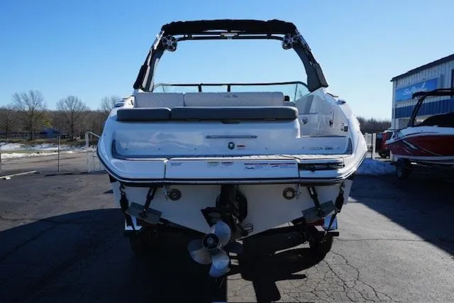 Slide: The Image of 2025 Sea Ray SDX 250 boat, rear view, parked outdoors. - 6