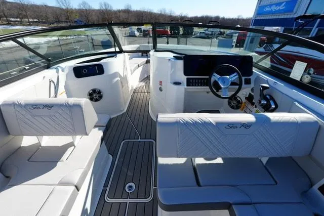 Slide: The Image of 2025 Sea Ray SDX 250 boat interior with white seating and modern dashboard. - 8
