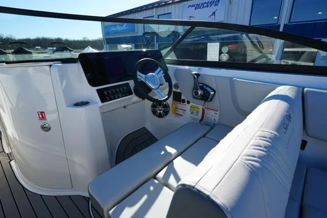 Slide: The Image of 2025 Sea Ray SDX 250 boat interior with steering wheel and seating. - 9