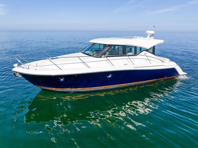 Slide: The Image of 2019 Tiara Yachts 39 Coupe on calm blue water, side view. - 1