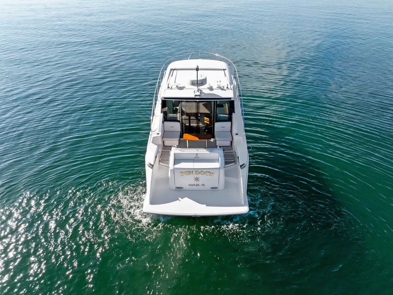 Slide: The Image of 2019 Tiara Yachts 39 Coupe cruising on calm blue waters. - 12