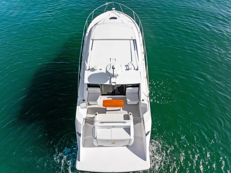 Slide: The Image of 2019 Tiara Yachts 39 Coupe cruising on clear blue water, aerial view. - 13