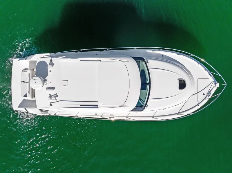 Slide: The Image of Aerial view of 2019 Tiara Yachts 39 Coupe on green water. - 14