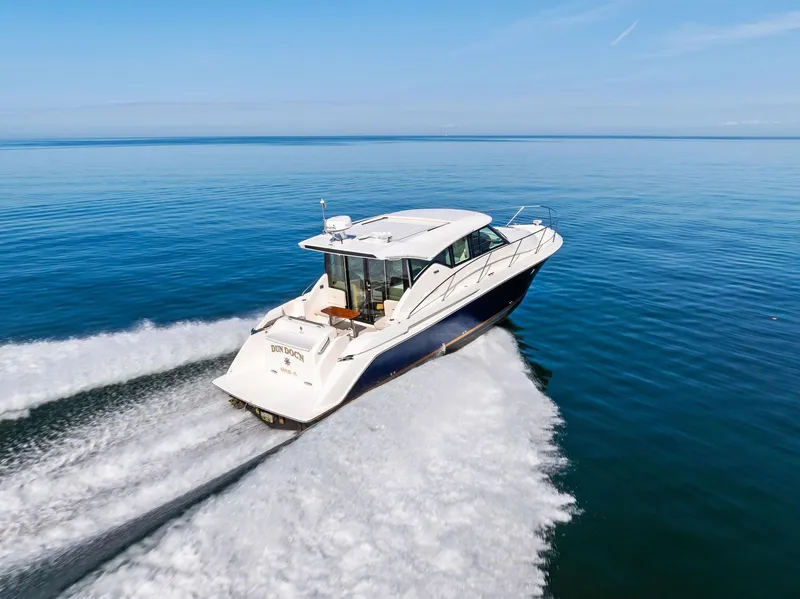 Slide: The Image of 2019 Tiara Yachts 39 Coupe cruising on open water, showcasing sleek design and performance. - 17