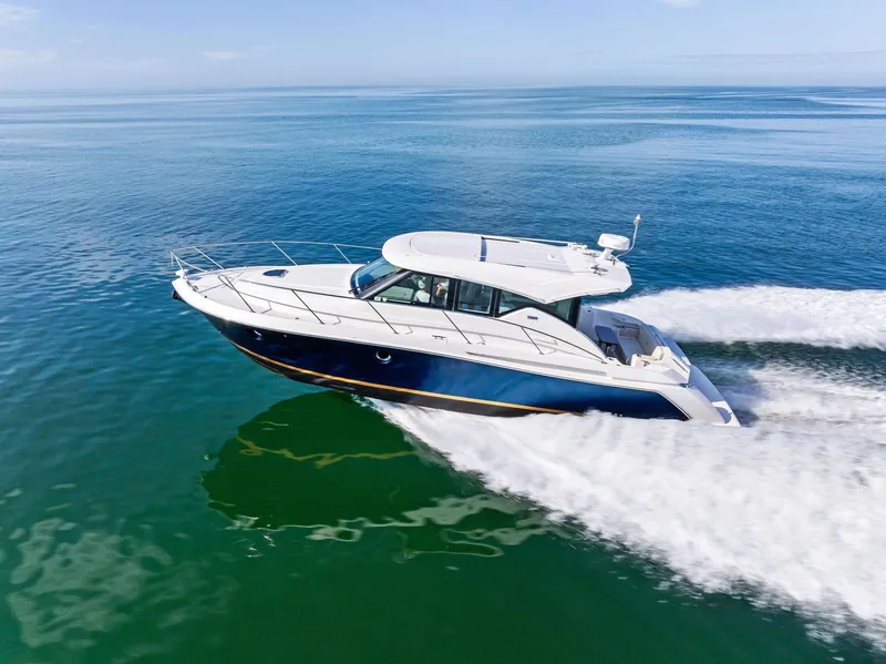 Slide: The Image of 2019 Tiara Yachts 39 Coupe cruising on open water, showcasing sleek design and performance. - 18