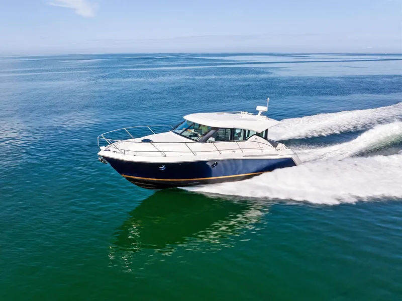 Slide: The Image of 2019 Tiara Yachts 39 Coupe cruising on open water, showcasing sleek design and performance. - 19