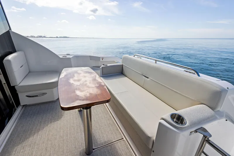 Slide: The Image of 2019 Tiara Yachts 39 Coupe deck with seating and ocean view. - 21