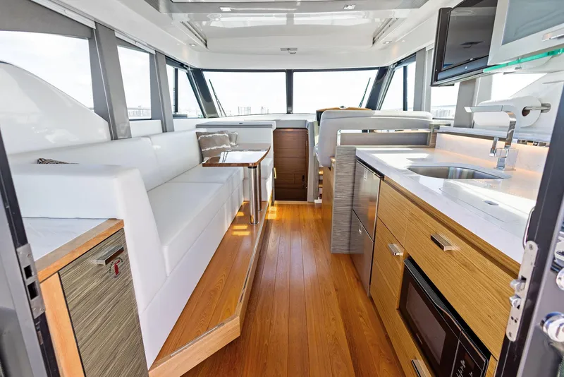 Slide: The Image of Interior of 2019 Tiara Yachts 39 Coupe, featuring modern kitchen and seating area. - 25