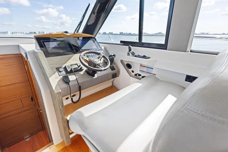 Slide: The Image of 2019 Tiara Yachts 39 Coupe helm with modern controls and panoramic windows. - 26