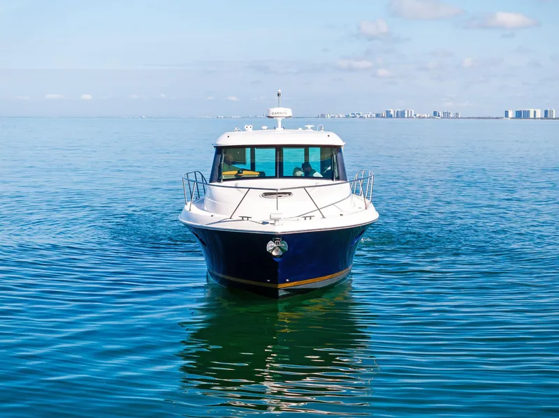 Slide: The Image of 2019 Tiara Yachts 39 Coupe cruising on calm blue waters. - 3