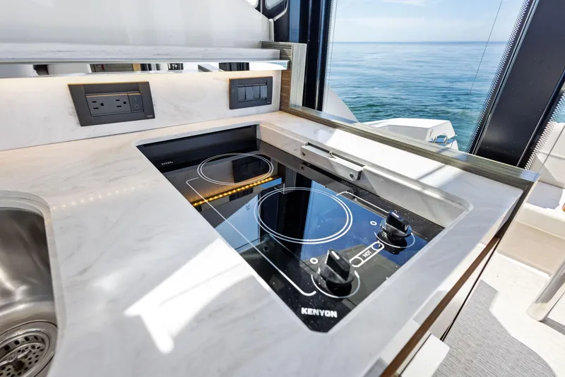 Slide: The Image of Modern kitchen area on 2019 Tiara Yachts 39 Coupe with ocean view. - 33