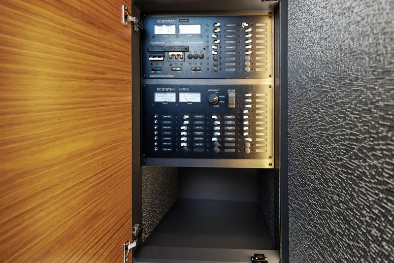 Slide: The Image of Electrical panel inside 2019 Tiara Yachts 39 Coupe, showcasing control switches and circuit breakers. - 35