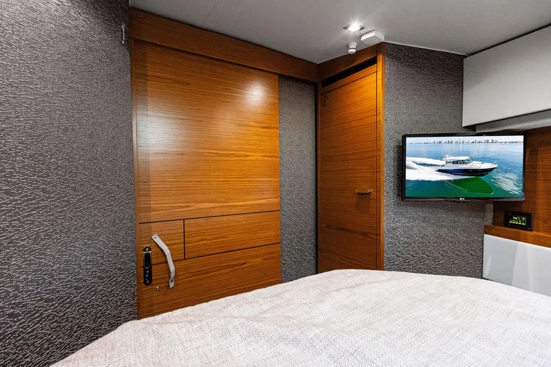 Slide: The Image of Interior of 2019 Tiara Yachts 39 Coupe with wooden door and wall-mounted TV. - 38