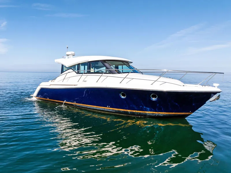 Slide: The Image of 2019 Tiara Yachts 39 Coupe on calm blue water under clear sky. - 4