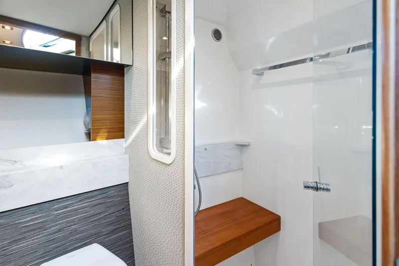 Slide: The Image of 2019 Tiara Yachts 39 Coupe bathroom with modern design and wooden accents. - 44