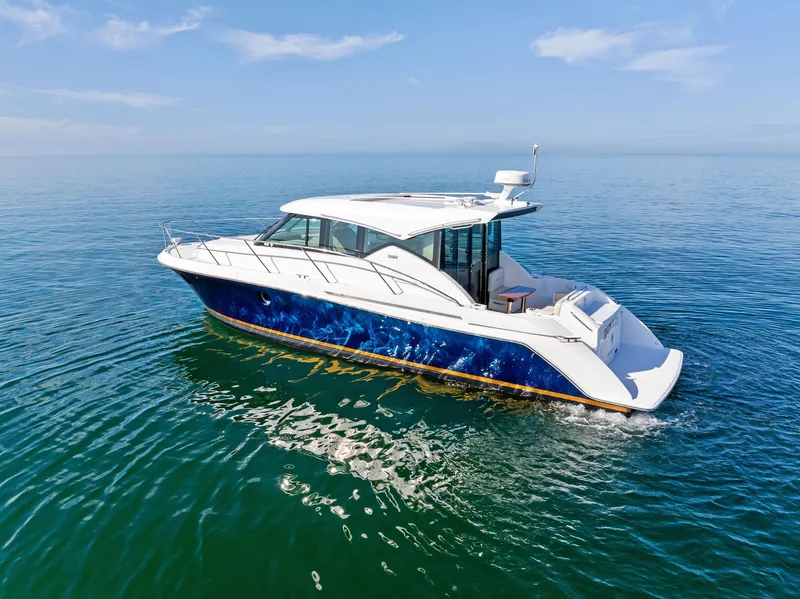 Slide: The Image of 2019 Tiara Yachts 39 Coupe cruising on calm blue waters under a clear sky. - 8