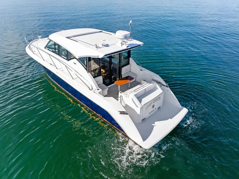 Slide: The Image of 2019 Tiara Yachts 39 Coupe cruising on clear blue water. - 9