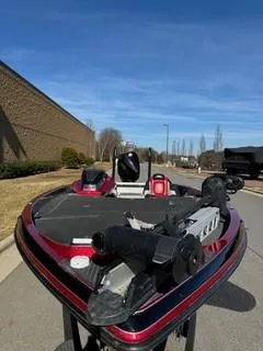 Slide: The Image of 2023 Ranger Z520R bass boat with red accents, parked outdoors under a clear blue sky. - 3
