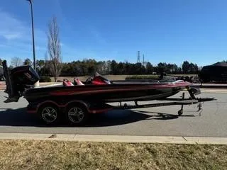 Slide: The Image of 2023 Ranger Z520R boat on trailer, parked on roadside under clear blue sky. - 4