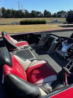 Slide: The Image of 2023 Ranger Z520R boat interior with red and black seats, steering wheel, and console. - 7