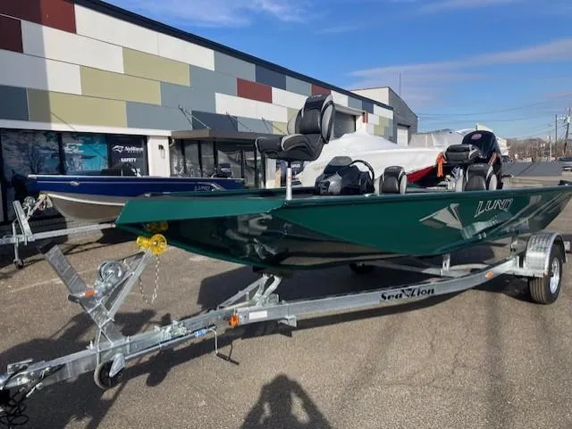 The Image of 2025 Lund 1875 Renegade SS boat on trailer, parked outside a modern building. - 0