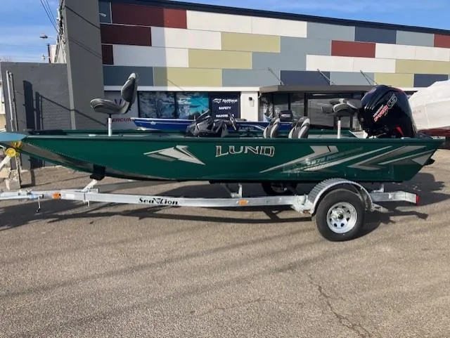 Slide: The Image of 2025 Lund 1875 Renegade SS boat on trailer, parked outdoors. - 1