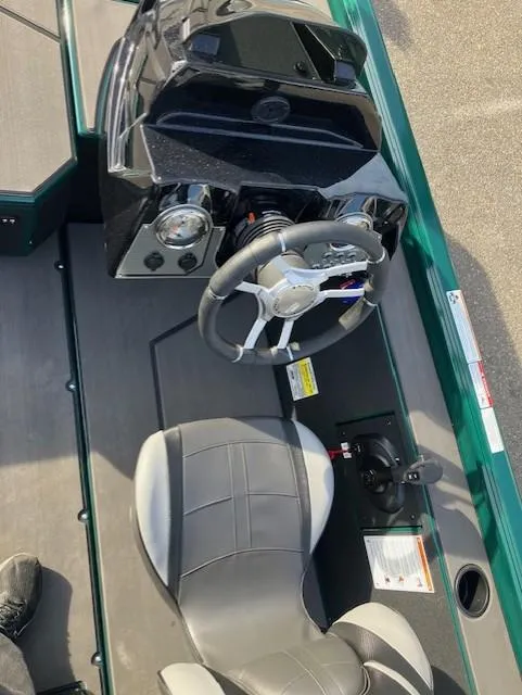 Slide: The Image of 2025 Lund 1875 Renegade SS boat interior with steering wheel and seat. - 14